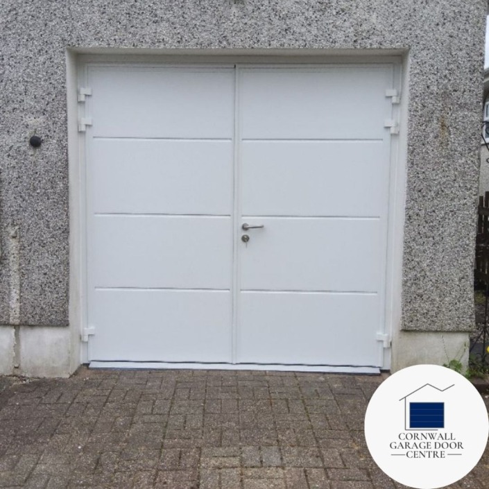 Image showcasing a pair of white insulated side hinged doors with a solid horizontal design. The doors are closed, emphasizing their sturdy construction and modern aesthetic.