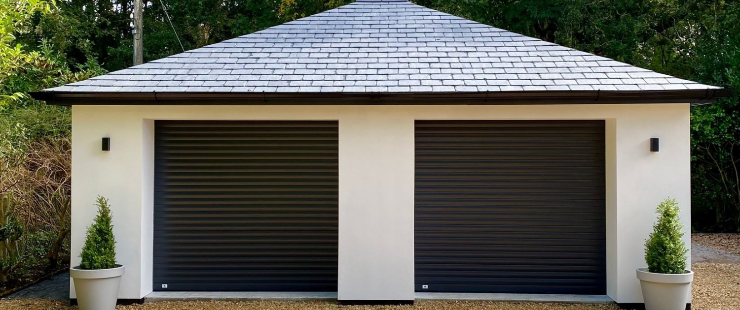 Modern garage with two dark roller doors
